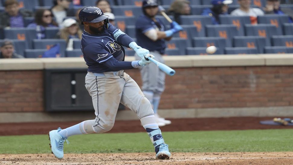 Tampa Bay Rays' Junior Caminero hits a home run, leading Taylor Walls and Brandon Lowe to score, during the ninth inning of a baseball game against the New York Mets, Sunday, June 15, 2025, in New York. (AP Photo/Pamela Smith)
