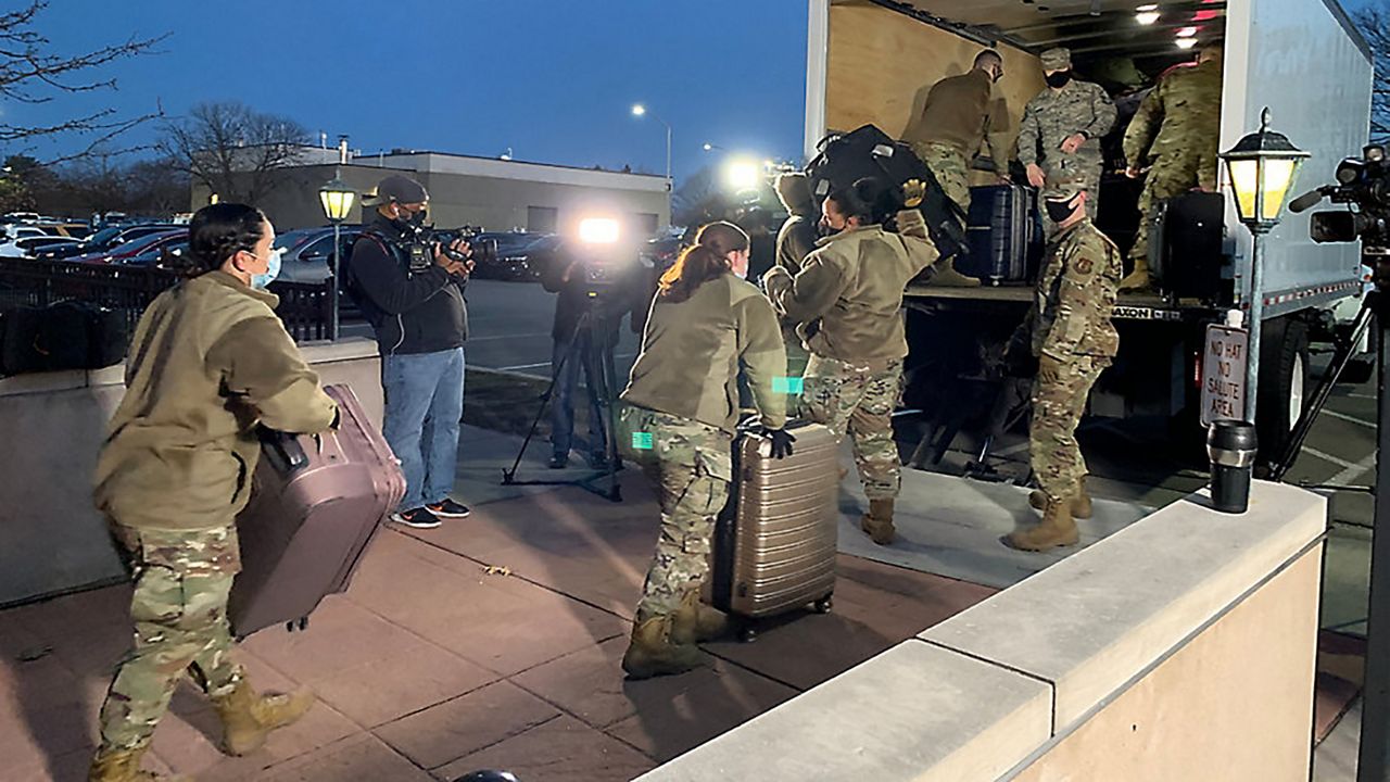 Airmen loading luggage onto truck for deployment 