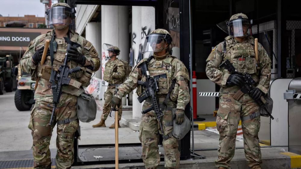 Members of the California National Guard in front of the Metropolitan Detention Center in downtown Los Angeles on Sunday. (Los Angeles Times/Jason Armond)