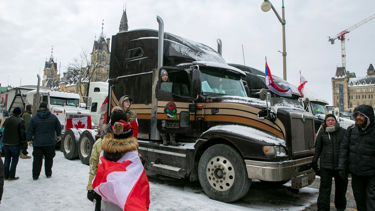 Stephanie Ravensbergen, 31, is in her family's truck in Ottawa, Ontario, Saturday, Feb. 12, 2022. She came to support her aunt and uncle, who have parked their semi in the streets since the beginning of the COVID-19 mandate protest. (AP Photo/Ted Shaffrey)