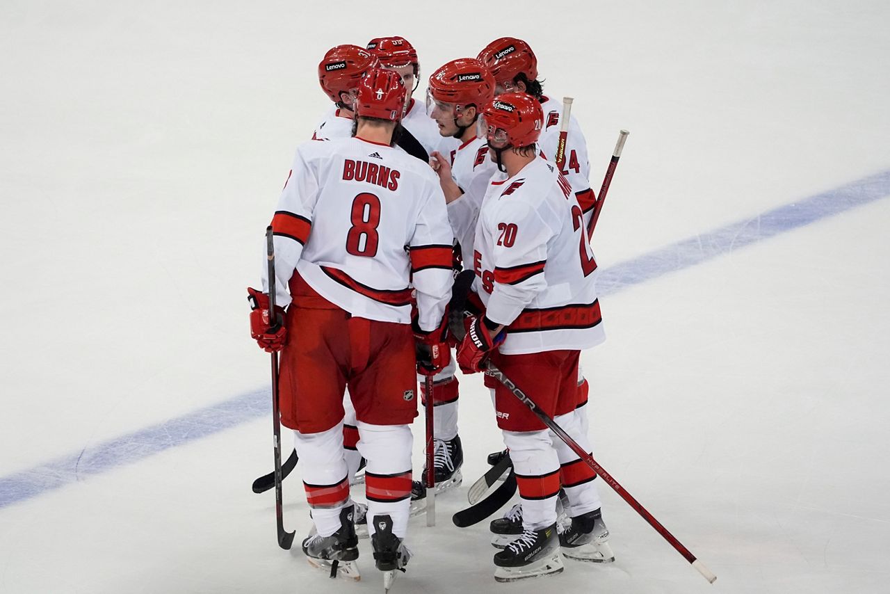 The Hurricanes first line huddle during the third period against the New York Rangers in Game 1 of an NHL hockey Stanley Cup second-round playoff series. (AP Photo/Julia Nikhinson)