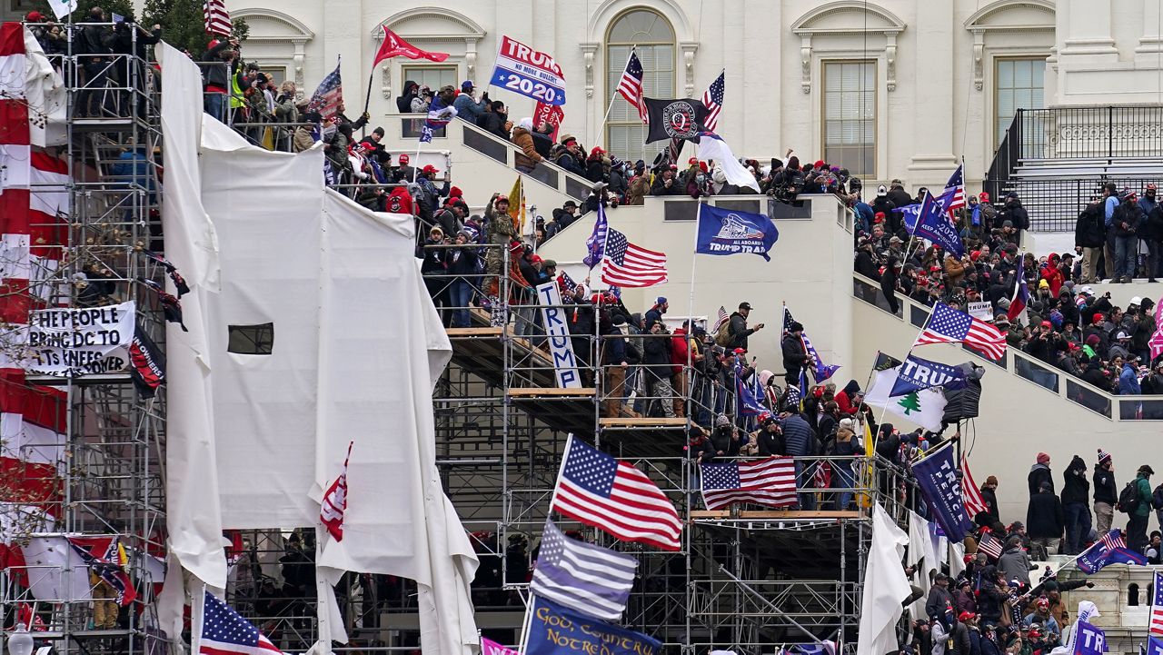In this Jan. 6, 2021 file photo insurrectionists loyal to President Donald Trump riot outside the Capitol in Washington. (AP Photo/John Minchillo, File)