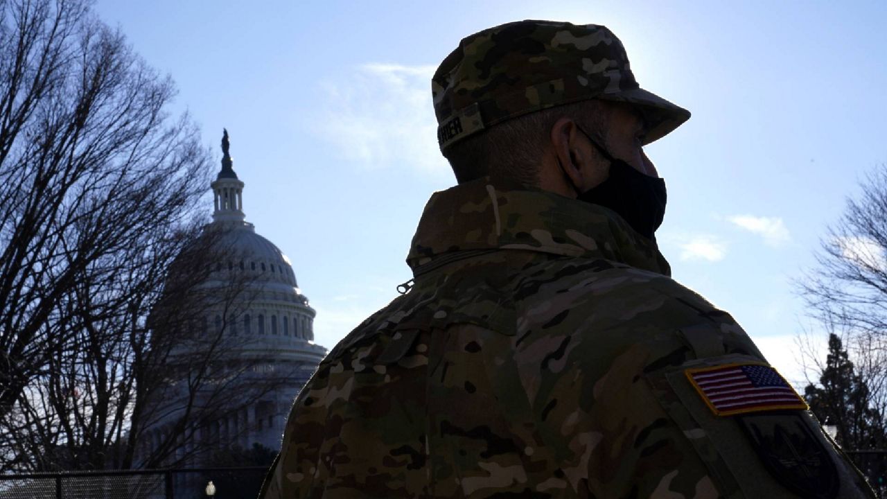 With the U.S. Capitol in the background, a member of the District of Columbia National Guard stands near newly-placed fencing around the Capitol grounds the day after violent protesters loyal to President Donald Trump stormed the U.S. Congress in Washington, Thursday, Jan. 7, 2021. (AP Photo/Matt Slocum)