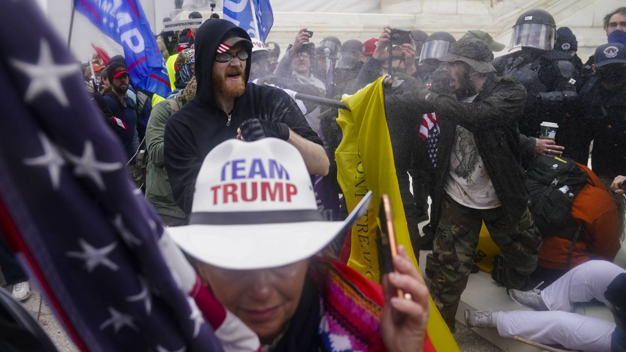 Insurrections loyal to President Donald Trump try to break through a police barrier at the Capitol on Jan. 6 in Washington. (AP Photo/John Minchillo, File)