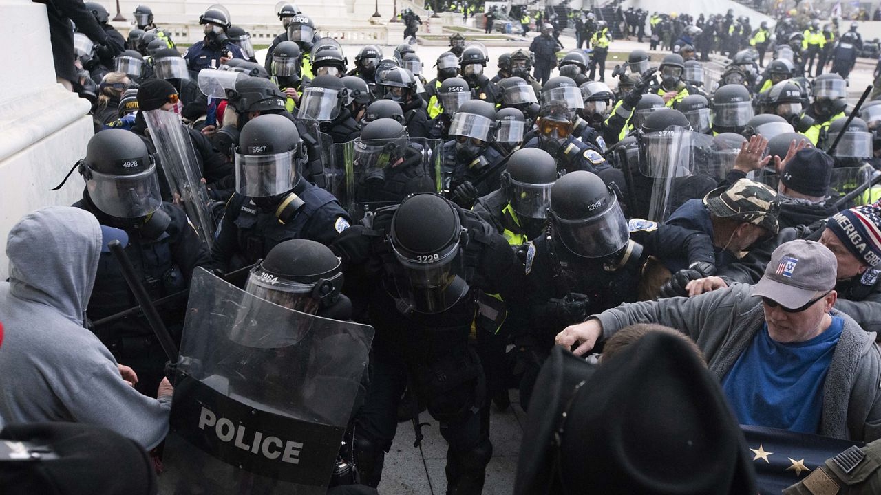 In this Jan. 6, 2021, file photo, U.S. Capitol Police push back rioters trying to enter the U.S. Capitol in Washington. Court papers say Federico Klein was seen wearing a "Make America Great Again" hat amid the throng of people trying to force their way into the Capitol. (AP Photo/Jose Luis Magana, File) 