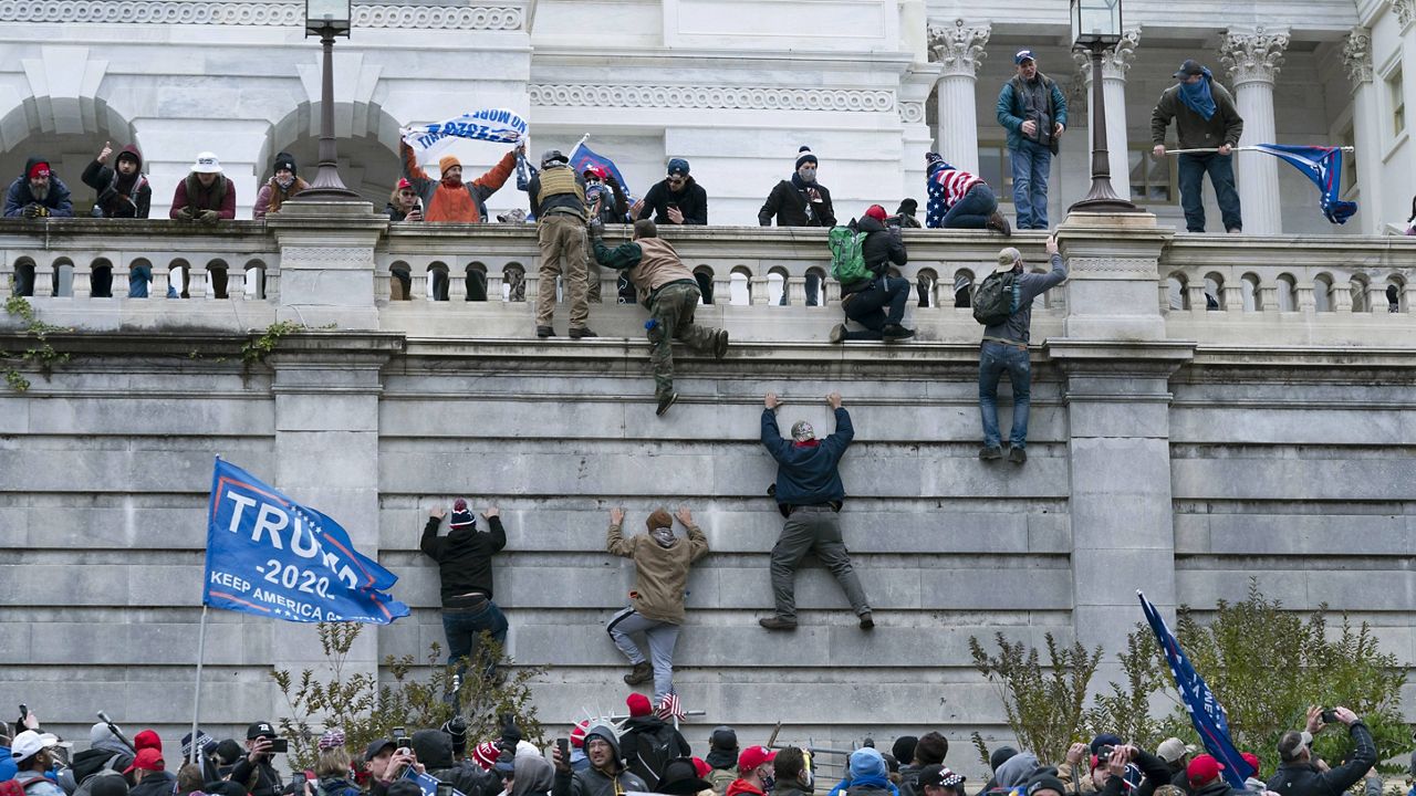 Jan. 6 rioters scale the U.S. Capitol building. (AP file)