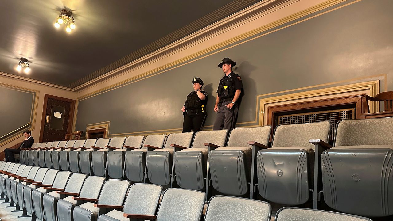 A Capitol police officer, left, stands with a Wisconsin state patrol officer at the top of the public gallery in the Assembly Chamber at the Wisconsin State Capitol in Madison, Wis., on Wednesday, June 18, 2025. 