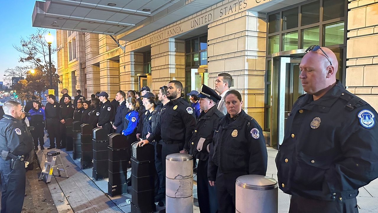 U.S. Capitol police officers stand outside the federal courthouse in Washington, Friday, Jan. 27, 2023, after attending the sentencing hearing for Julian Khater and co-defendant, George Tanio. Both men joined the mob that stormed the Capitol on Jan. 6, 2021. (AP Photo/Michael Kunzelman)