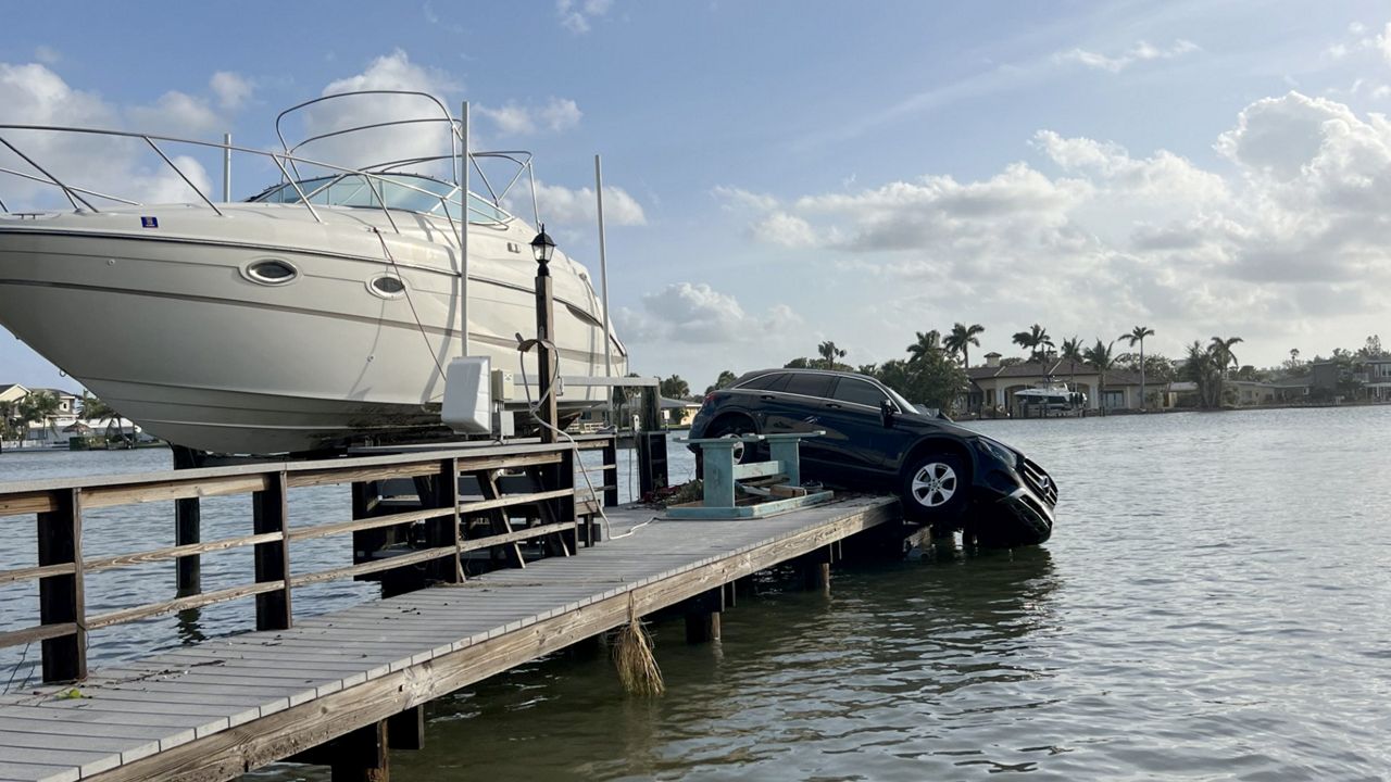 Car hanging off of a dock after Hurricane Helene made its way through the area (Courtesy: Valerie Stunja))