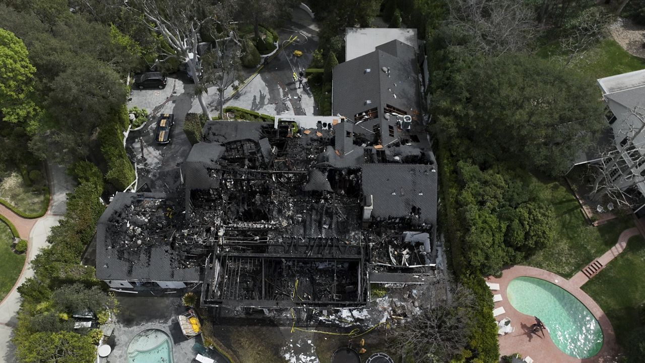 An aerial view shows a fire-damaged property, which appears to belong to Cara Delevingne, Friday, March 15, 2024, in the Studio City section of Los Angeles. (AP Photo/Jae C. Hong)