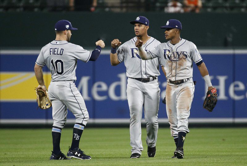 Tampa Bay Rays outfielders Johnny Field, Carlos Gomez and Mallex Smith, from left, fist-bump after the second baseball game of a doubleheader against the Baltimore Orioles, Saturday, May 12, 2018, in Baltimore. Tampa Bay won 10-3. (AP Photo/Patrick Semansky)