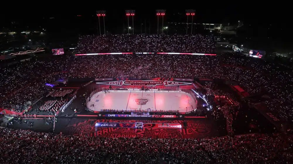 Fans hold lighted cellphones as the lights are dimmed before an NHL hockey Stadium Series game between the Washington Capitals and the Carolina Hurricanes on Feb. 18, 2023, in Raleigh, N.C. Carolina will take on the Florida Panthers in the Eastern Conference Final, with Game 1 on Thursday, May 18. (AP Photo/Chris Seward, File)