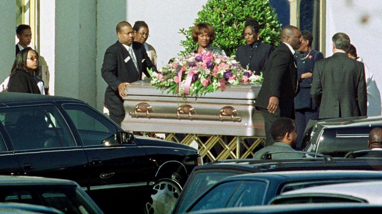 The casket carrying the body of Cherica Adams leaves a church in Charlotte, N.C., after her funeral Saturday, Dec. 18, 1999. Adams died Tuesday, Dec. 15 after being shot on Nov. 16 in a drive-by shooting. Former Carolina Panthers receiver Rae Carruth is charged along with three others in her death. (AP Photo/Rusty Burroughs)