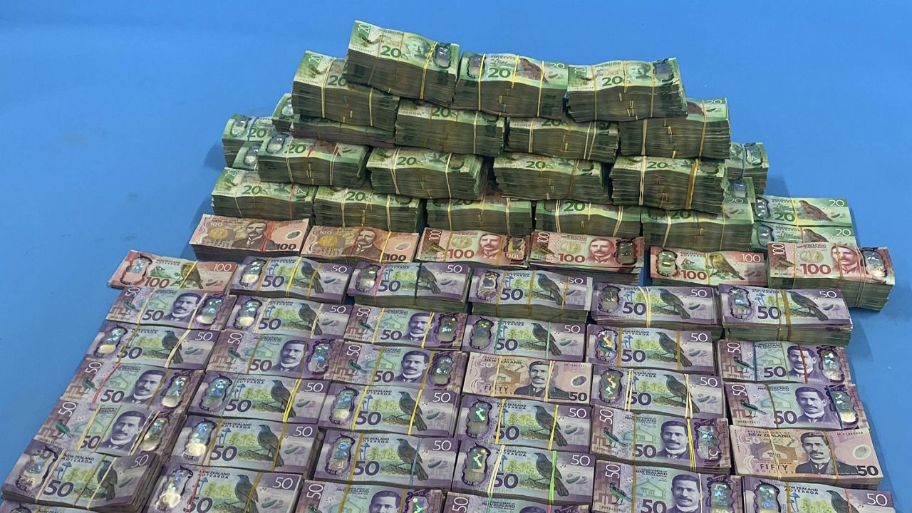 In this photo supplied by the New Zealand police, a large amount of cash seized in Operation Trojan Shield is displayed. (New Zealand Police via AP)