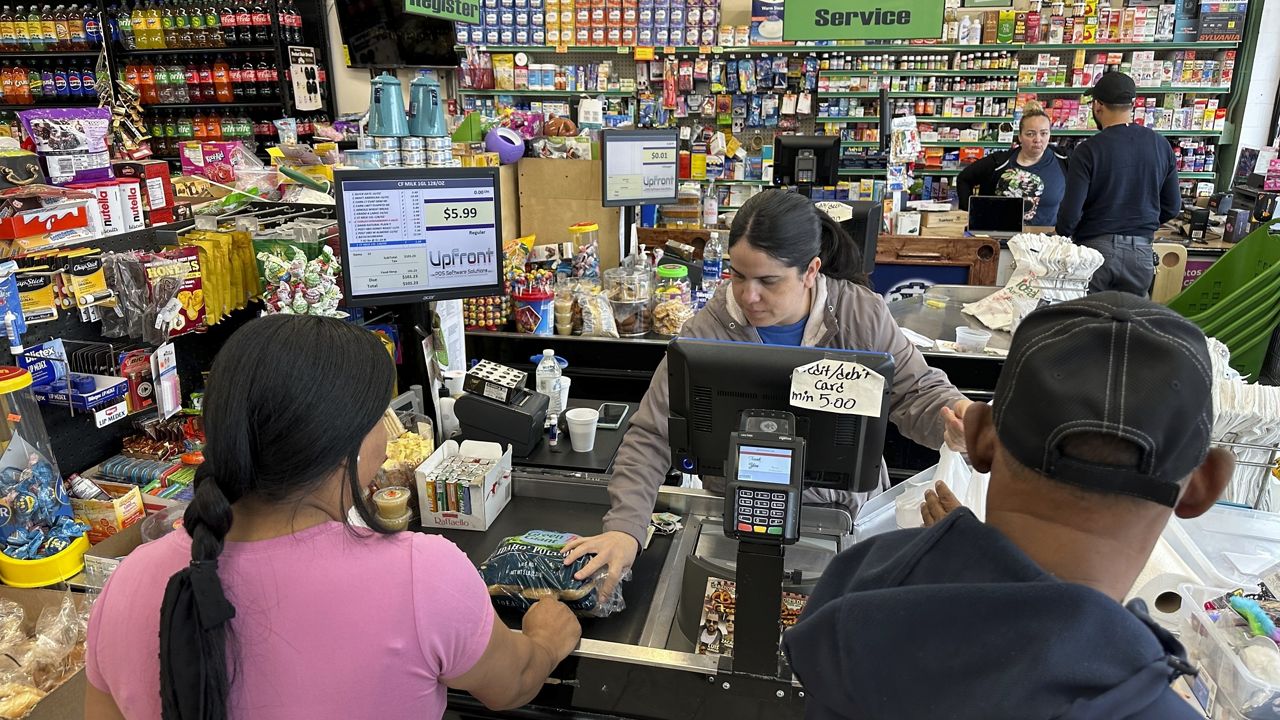 Cashier Rosa Dilone helps customers at Mi Tierra Supermarket in Hazleton, Pa., on May 16, 2024. (AP Photo/Mark Scolforo, File)