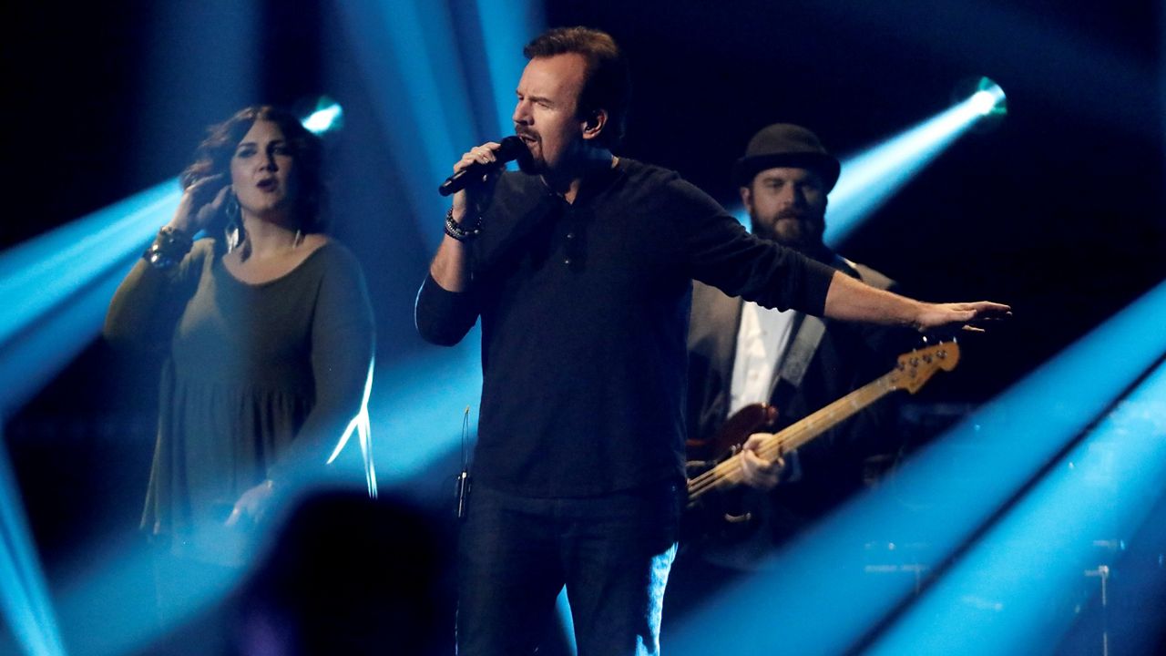 Mark Hall, center, and Casting Crowns perform during the Dove Awards on Tuesday, Oct. 15, 2019, in Nashville, Tenn. (AP Photo/Mark Humphrey)