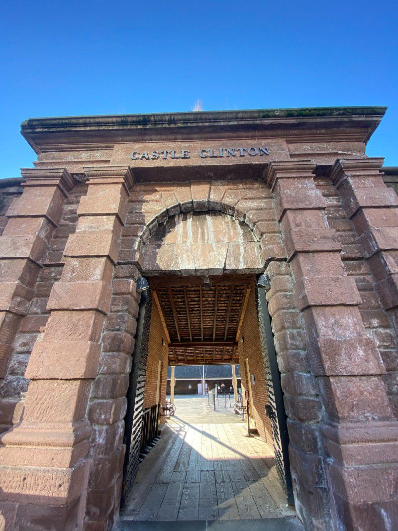 An exterior shot of an entrance archway of Castle Clinton.