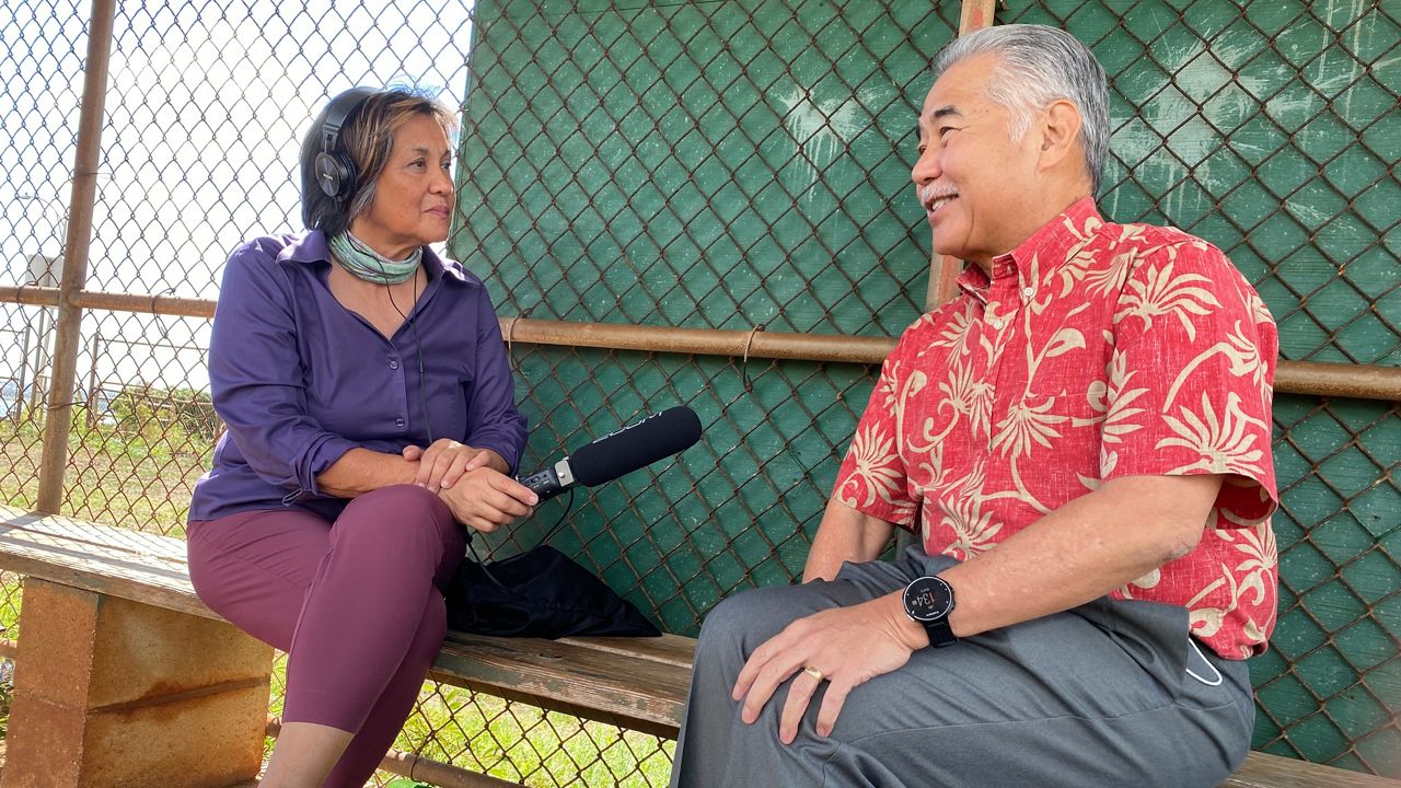Catherine Cruz interviews Gov. David Ige in November 2022 for Hawaii Public Radio at Newtown Neighborhood Park where his children used to play while he was in his "final inning" as his last day in office approached. (Photo courtesy of Catherine Cruz)