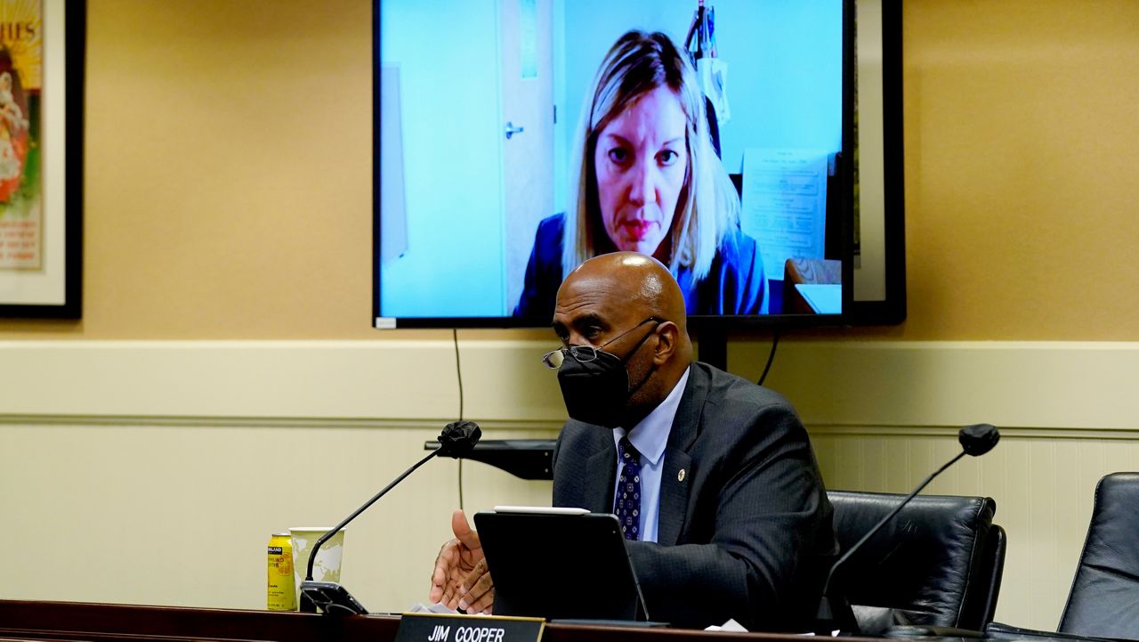 Assemblyman Jim Cooper, D-Elk Grove asks a question to Nancy Farias, the newly appointed director of the California Employment Development Department, seen in video monitor, during a hearing of an Assembly budget subcommittee at the Capitol in Sacramento, Calif., Tuesday, Feb. 22, 2022. 