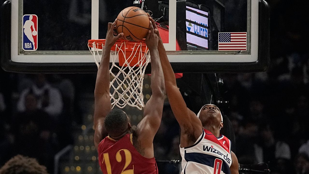 Washington Wizards guard Bilal Coulibaly (0) blocks a dunk by Cleveland Cavaliers center Tristan Thompson (12) in the first half of an NBA basketball game Wednesday, Jan. 3, 2024 in Cleveland. (AP Photo/Sue Ogrocki)