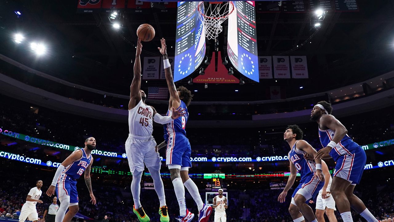 Cleveland Cavaliers' Donovan Mitchell (45) goes up for a shot against Philadelphia 76ers' Kelly Oubre Jr. (9) during the first half of an NBA basketball game, Wednesday, Nov. 13, 2024, in Philadelphia. (AP Photo/Matt Slocum)