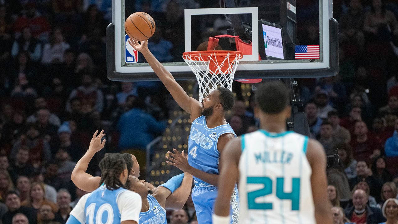 Cleveland Cavaliers' Evan Mobley (4) goes for the ball in front of teammate Isaac Okoro (35), Darius Garland (10) and Charlotte Hornets' Brandon Miller (24) during the first half of an NBA basketball game in Cleveland, Sunday, Nov 17, 2024. (AP Photo/Phil Long)