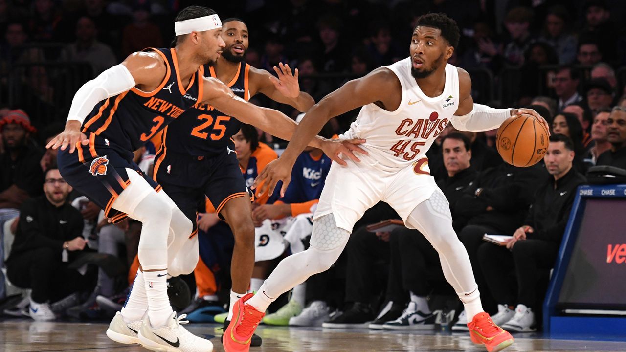 Cleveland Cavaliers' Donovan Mitchell, right, dribbles the ball against New York Knicks' Josh Hart, left, during the first half of an NBA basketball game, Monday, Oct. 28, 2024, in New York. (AP Photo/Pamela Smith)