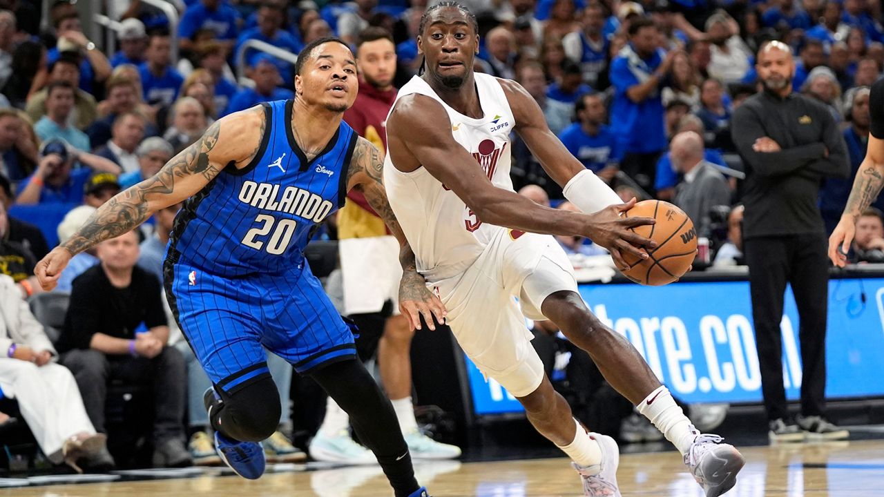 Cleveland Cavaliers guard Caris LeVert, right, drives past Orlando Magic guard Markelle Fultz (20) during the first half of Game 3 of an NBA basketball first-round playoff series Thursday, April 25, 2024, in Orlando, Fla. (AP Photo/John Raoux)