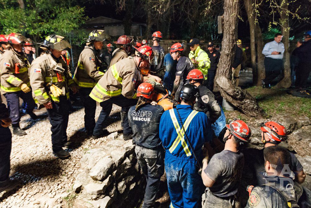 First responders getting the teen out of the cave. (Credit: SAFD Facebook)