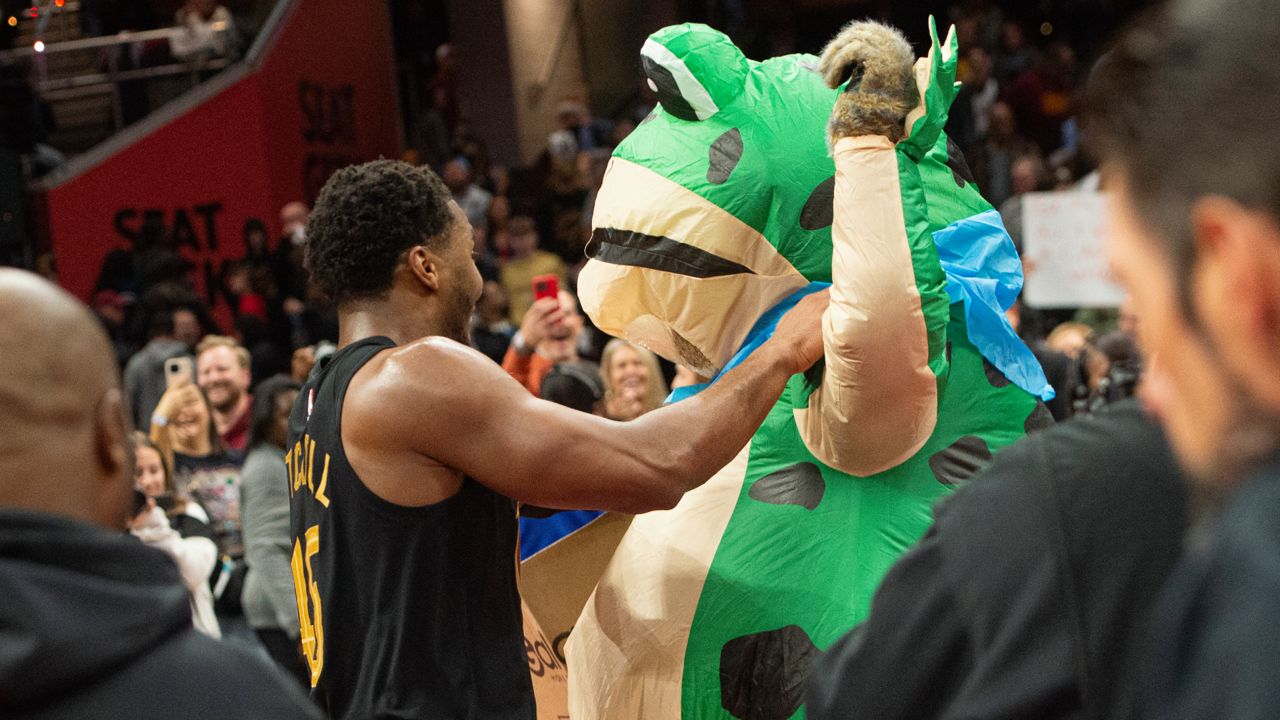 Cleveland Cavaliers' Donovan Mitchell, center left, dances with someone dressed as giant frog after an Emirates NBA cup basketball game against the Chicago Bulls in Cleveland, Friday, Nov 15, 2024. 