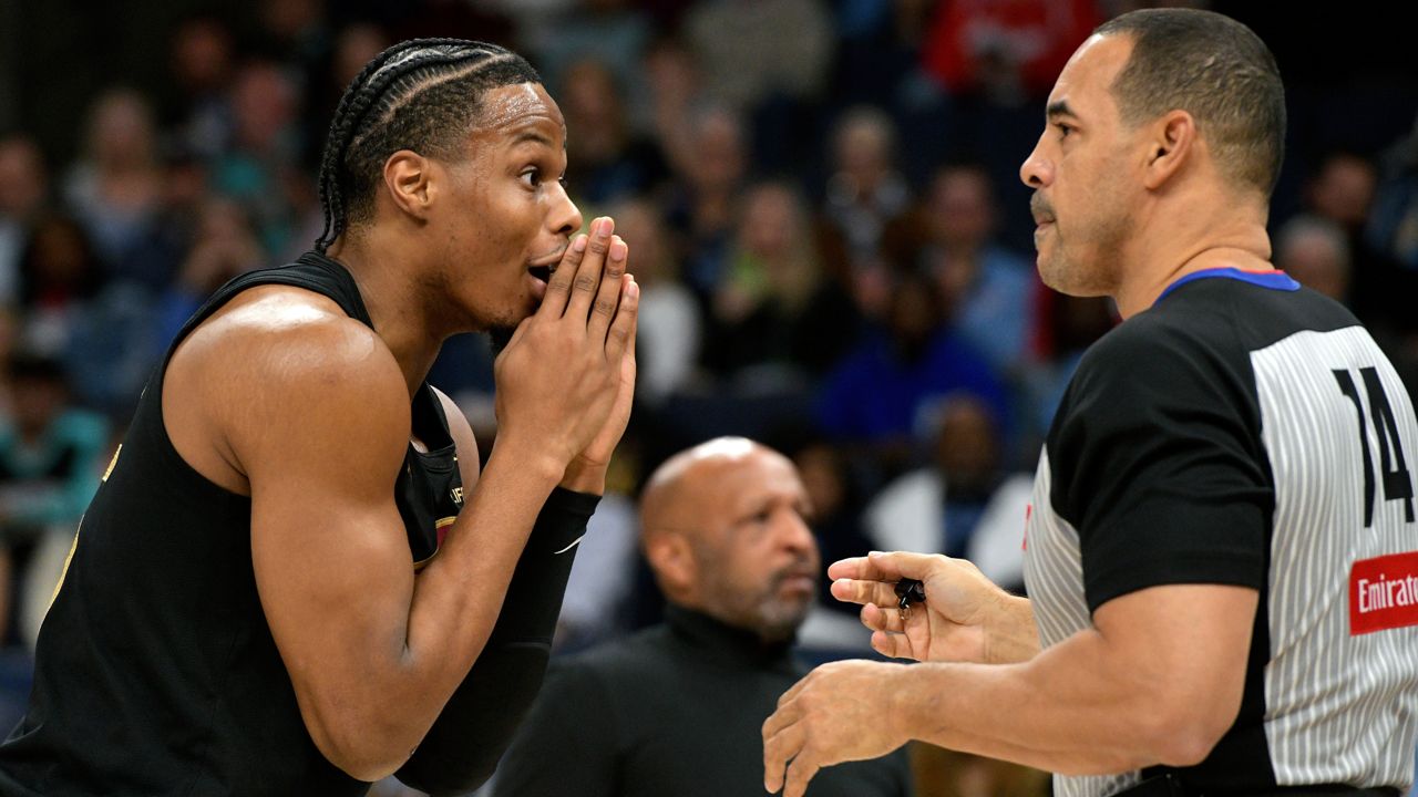 Cleveland Cavaliers forward Isaac Okoro, left, reacts to a call by referee Curtis Blair (74) in the first half of an NBA basketball game against the Memphis Grizzlies, Friday, March 14, 2025, in Memphis, Tenn.