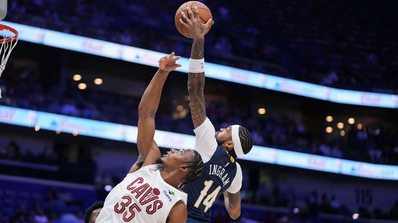 New Orleans Pelicans forward Brandon Ingram (14) leaps for a rebound over Cleveland Cavaliers forward Isaac Okoro (35) in the first half of an NBA basketball game in New Orleans, Wednesday, Nov. 6, 2024. (AP Photo/Gerald Herbert)