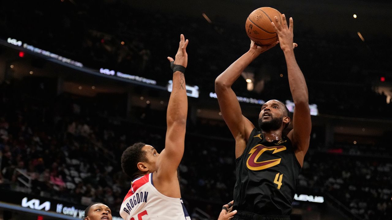 Cleveland Cavaliers forward Evan Mobley (4) shoots over Washington Wizards guard Malcolm Brogdon (15) in the first half of an NBA Cup basketball game, Tuesday, Dec. 3, 2024, in Cleveland. (AP Photo/Sue Ogrocki)