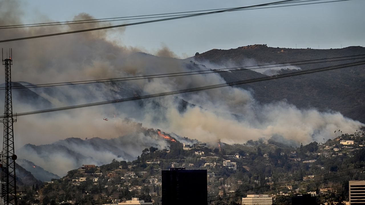 Small fires are seen along a hillside burn the Brentwood section of Los Angeles on Wednesday, Jan. 8, 2025. (AP Photo/Richard Vogel)