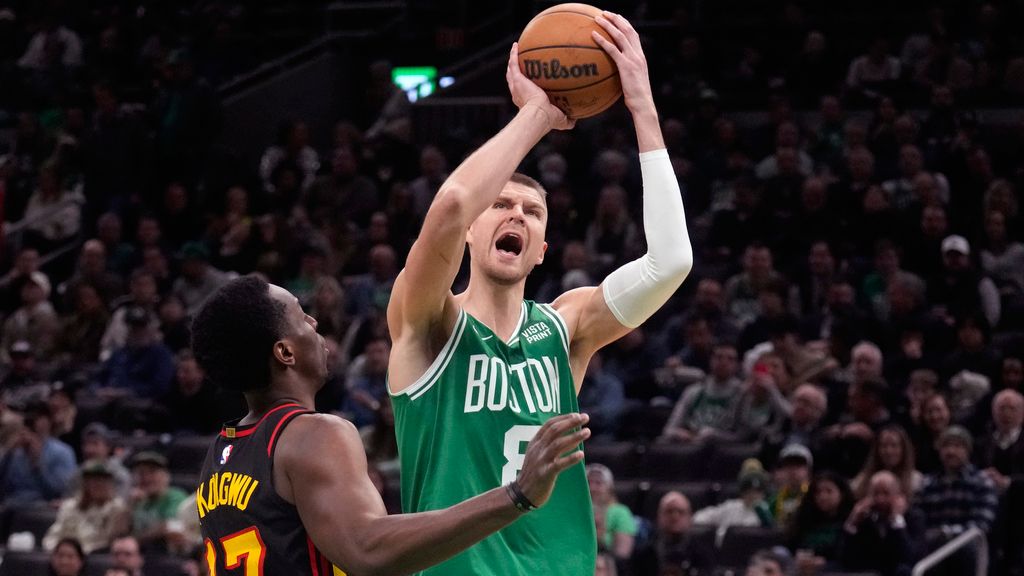 Boston Celtics center Kristaps Porzingis (8) drives to the basket against Atlanta Hawks forward Onyeka Okongwu (17) during the first half of an NBA basketball game Wednesday, Feb. 7, 2024, in Boston. (AP Photo/Charles Krupa)