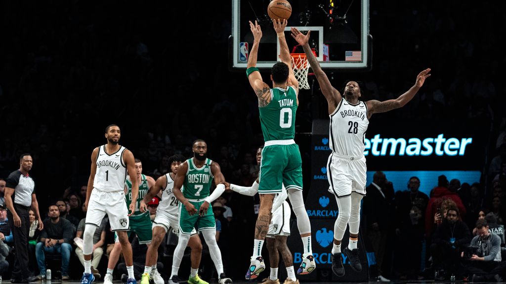 Boston Celtics forward Jayson Tatum (0) shoots against Brooklyn Nets forward Dorian Finney-Smith (28) during the first half of an NBA basketball game in New York, Tuesday, Feb. 13, 2024. (AP Photo/Peter K. Afriyie)