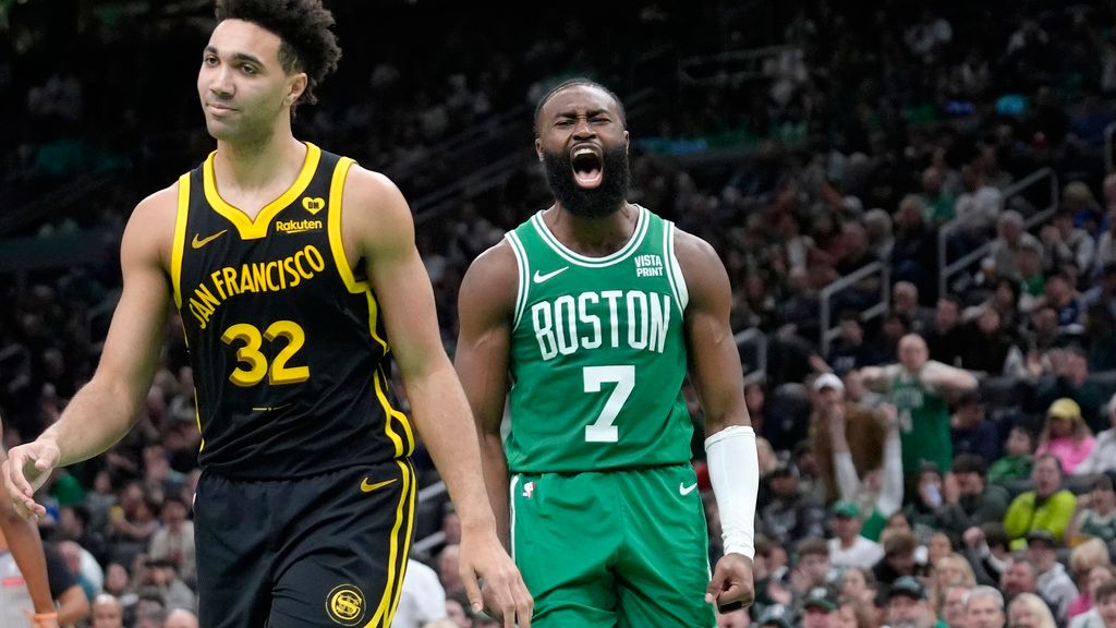 Boston Celtics guard Jaylen Brown (7) celebrates near Golden State Warriors forward Trayce Jackson-Davis (32) after scoring in the second half of an NBA basketball game, Sunday, March. 3, 2024, in Boston. (AP Photo/Steven Senne)