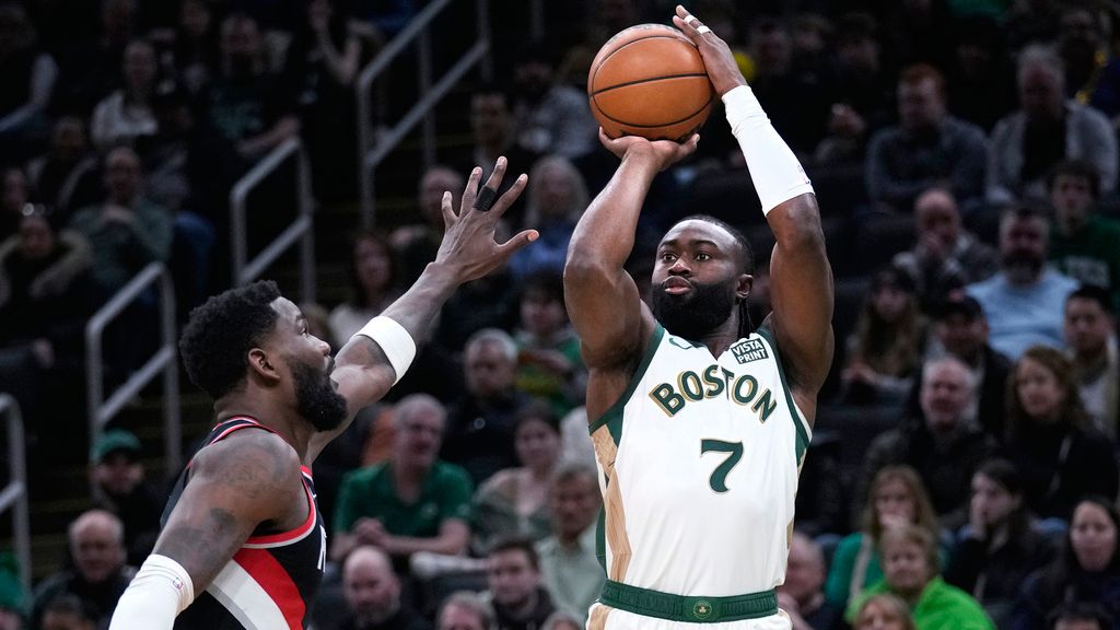 Boston Celtics guard Jaylen Brown (7) takes a shot over Portland Trail Blazers center Deandre Ayton, left, during the first half of an NBA game, Sunday, April 7, in Boston. (AP Photo/Charles Krupa)