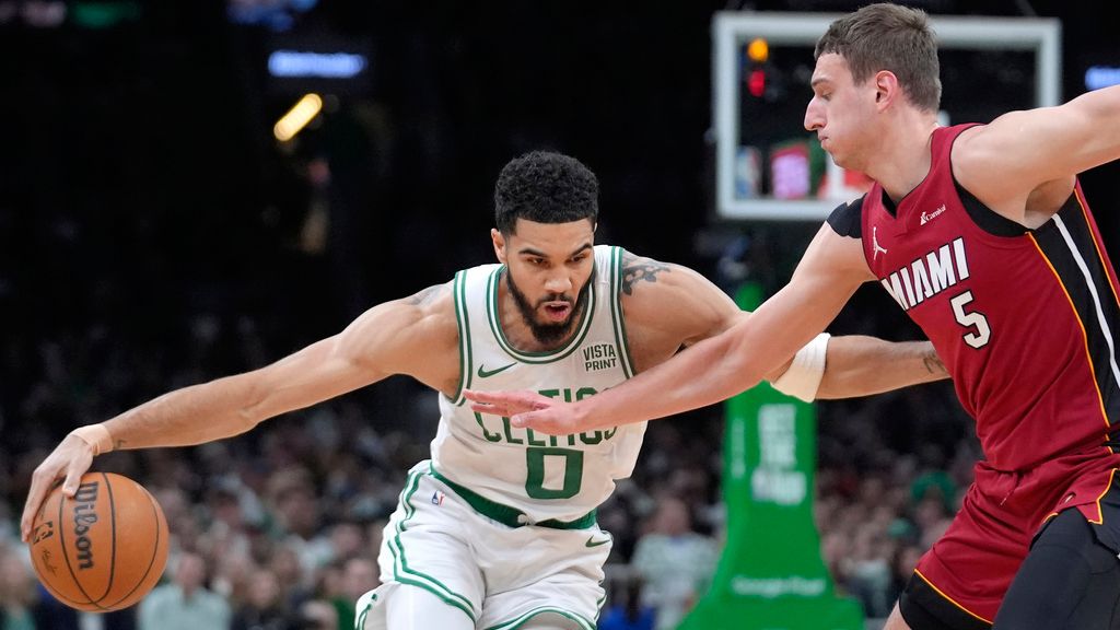 Boston Celtics forward Jayson Tatum (0) drives past Miami Heat forward Nikola Jovic (5) in the first half of Game 1 of an NBA basketball first-round playoff series, Sunday, April 21, 2024, in Boston. (AP Photo/Steven Senne)