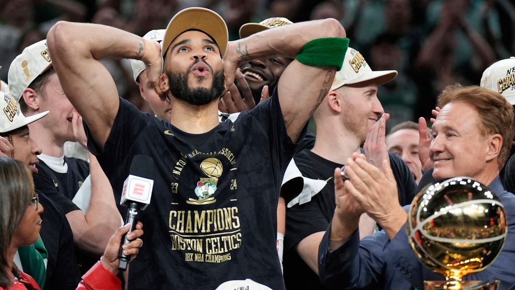 Boston Celtics forward Jayson Tatum, left, celebrates next to Celtics co-owner Stephen Pagliuca, right, near the Larry O'Brien Championship Trophy after the Celtics won the NBA championship with a Game 5 victory over the Dallas Mavericks on Monday, June 17, 2024, in Boston. (AP Photo/Charles Krupa)