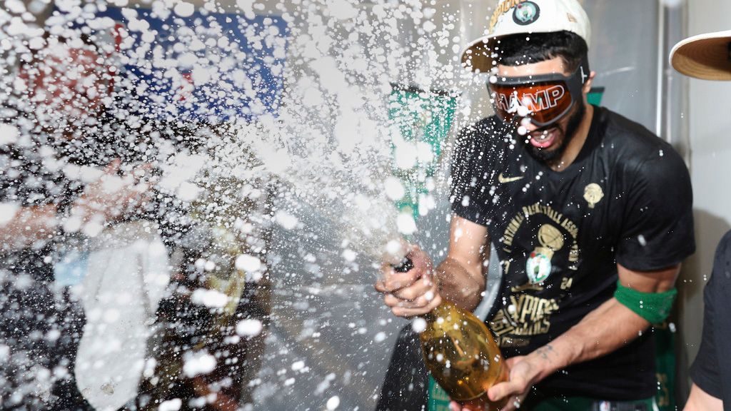 Boston Celtics forward Jayson Tatum sprays champagne while celebrating after defeating the Dallas Mavericks in Game 5 to win the NBA basketball finals Monday, June 17, 2024, in Boston. (Elsa/Pool Photo via AP)
