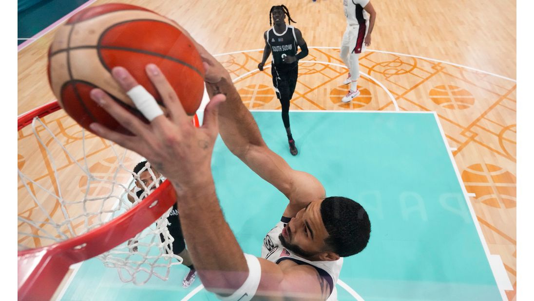 Jayson Tatum, of the United States, gets a basket on a dunk against South Sudan in a men's basketball game at the 2024 Summer Olympics, Wednesday, July 31, 2024, in Villeneuve-d'Ascq, France. (AP Photo/Mark J. Terrill, Pool)