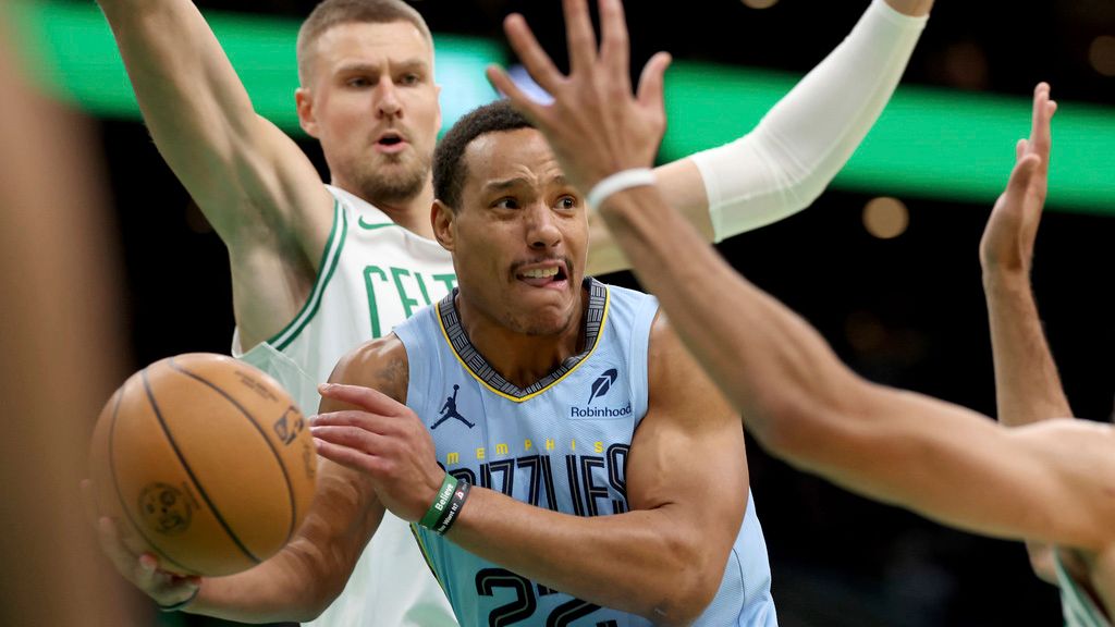 Memphis Grizzlies guard Desmond Bane (22) looks to pass in front of Boston Celtics center Kristaps Porzingis during the first half of an NBA basketball game, Saturday, Dec. 7, 2024, in Boston. (AP Photo/Mark Stockwell)