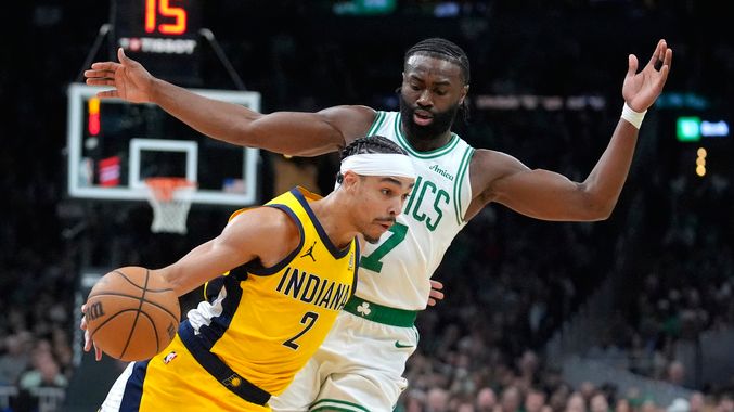 Indiana Pacers guard Andrew Nembhard (2) drives toward the basket in front of Boston Celtics guard Jaylen Brown (7) in the first half of an NBA basketball game, Sunday, Dec. 29, 2024, in Boston. (AP Photo/Steven Senne)