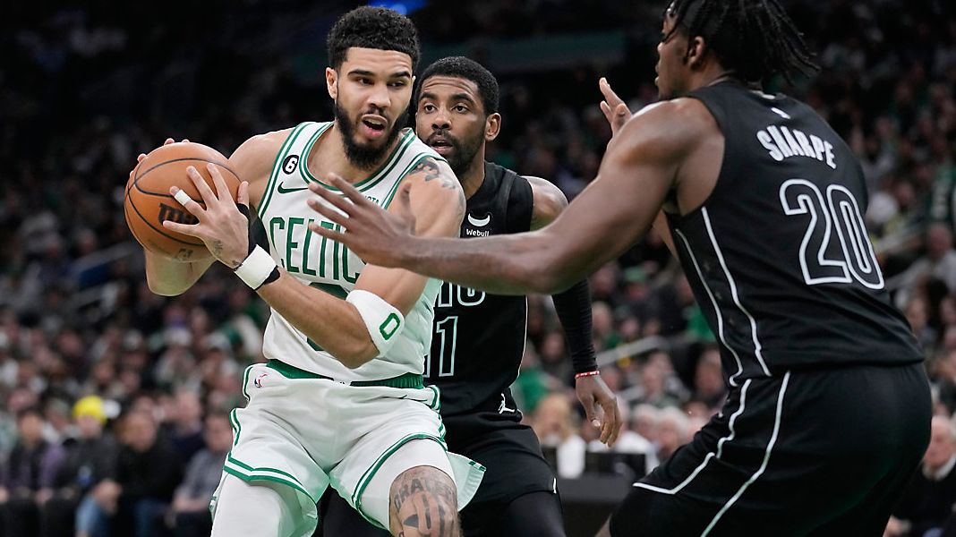 Boston Celtics forward Jayson Tatum, left, is trapped between Brooklyn Nets center Day'Ron Sharpe (20) and guard Kyrie Irving, rear, during the first half of an NBA game, Wednesday, Feb. 1, 2023, in Boston. The two teams face off on Tuesday. (AP Photo/Charles Krupa)