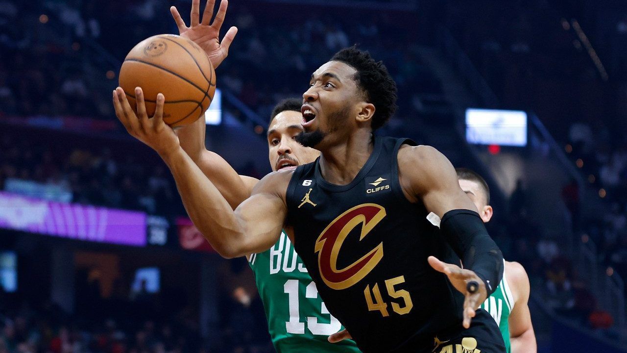 Cleveland Cavaliers guard Donovan Mitchell (45) shoots against Boston Celtics guard Malcolm Brogdon during the first half of an NBA basketball game, Monday, March 6, 2023, in Cleveland. 