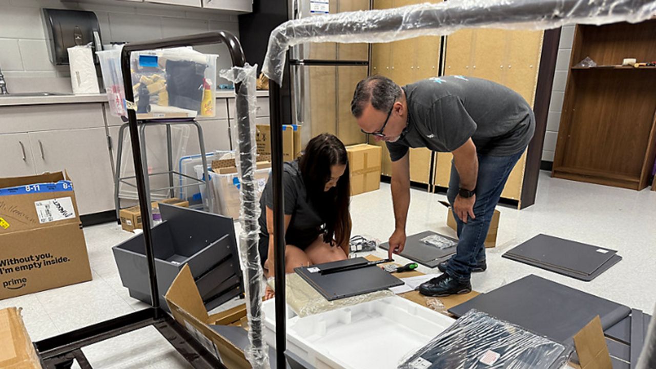 Volunteers build furniture at Millennium Middle School