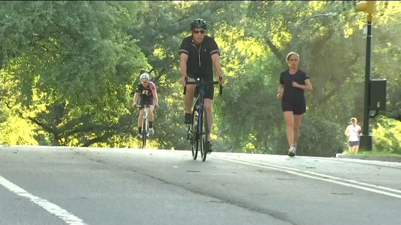 Two bicyclists and a jogger use a park in this undated file image. (Spectrum News file image)