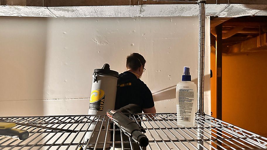 A restoration worker cleans mold in a house flooded by Tropical Storm Chantal. (Spectrum News 1/Patrick Thomas) 