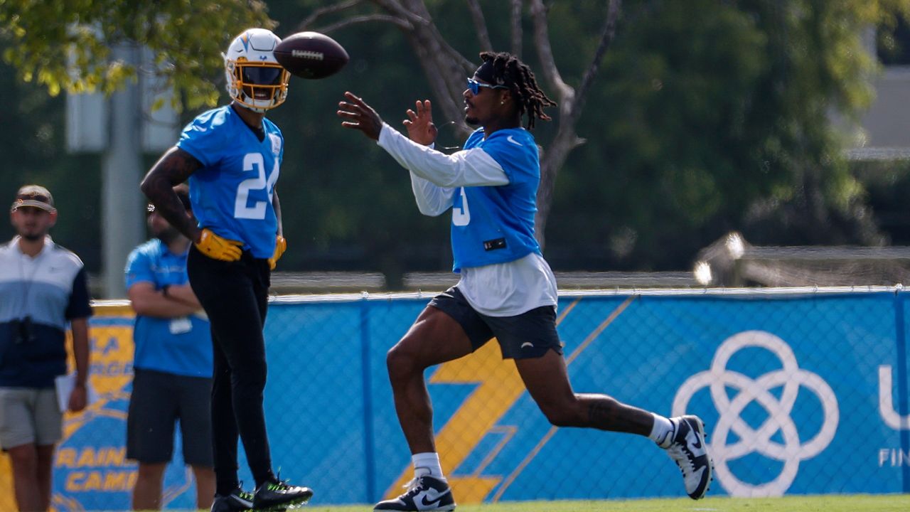 Los Angeles Chargers safeties Derwin James Jr., right, throws a ball as Nasir Adderley (24) looks on during the NFL football team's training camp, Wednesday, July 27, 2022, in Costa Mesa, Calif. (AP Photo/Ringo H.W. Chiu)
